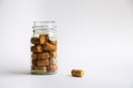 Wine corks lie in a glass jar on a white background Royalty Free Stock Photo