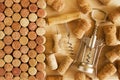 Wine corks and two corkscrews on the wooden background.