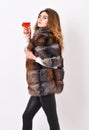 Wine culture concept. Woman drink wine. Girl fashion makeup wear fur coat hold glass alcohol. Elite leisure. Reasons