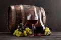 Wine decanter, glass and old wooden barrel