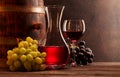 Wine decanter, glass of red wine and old wooden barrel