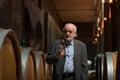 Wine expert tasting white wine in a wine cellar