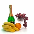 Wine and fruit. There are several yellow bananas and an orange Royalty Free Stock Photo