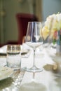 wine glass and beverage glasson served dining table with utensils and flowers