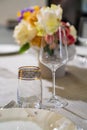 wine glass and beverage glasson served dining table with utensils and flowers