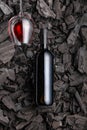 Wine glass with bottle with wine with corks on black coal background Poster concept design photo shooting Royalty Free Stock Photo