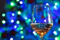 Wine Glass with the Christmas lights on the background Royalty Free Stock Photo