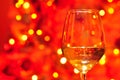 Wine Glass with the Christmas lights on the background Royalty Free Stock Photo