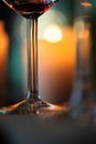 Wine glass closeup, candle light bokeh in the background.