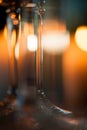 Wine glass closeup, candle light bokeh in the background.