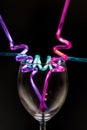 Wine glass and colourful straws. Royalty Free Stock Photo