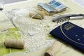 Wine glass and corks on map for route planning. Brazilian passport and real notes Royalty Free Stock Photo