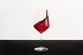 Red wine splashing out of a glass Royalty Free Stock Photo