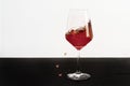 Red wine splashing out of a glass Royalty Free Stock Photo