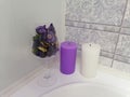 A wine glass with dry flowers and two candles on the edge of the bath. Royalty Free Stock Photo