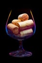 A wine glass filled corks with lighted multi-colored gradient Royalty Free Stock Photo