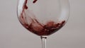 Wine glass filled rose alcohol drink in super slow motion close up. Red beverage Royalty Free Stock Photo