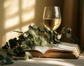 wine glass in front of books, light yellow and white, detailed foliage