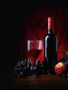 Wine, glass, fruits and red background