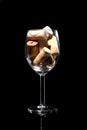 Wine glass full of wine cork stoppers isolated on black background  and copy space for your text Royalty Free Stock Photo