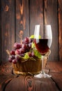 Wine glass and grapes in a basket Royalty Free Stock Photo