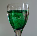 Wine glass with green food coloring Royalty Free Stock Photo