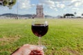 Wine glass in hand near 16th century tower Belem in Portugal. Beautiful landscape and popular destination for travellers Royalty Free Stock Photo
