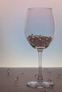 Wine glass, with ice cubes on white. Concept of precious stones in glass Royalty Free Stock Photo