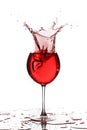 Wine glass with liquid splash on white Royalty Free Stock Photo