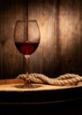 Wine glass and old wooden barrel close-up Royalty Free Stock Photo