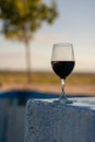 Wine glass on pool edge at sunset Royalty Free Stock Photo