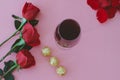 Wine glass with red roses and chocolates. Valentine`s Day Royalty Free Stock Photo