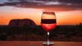 Wine glass with red wine at sunset. Australian wine concept. Royalty Free Stock Photo
