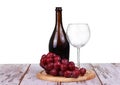 Wine glass with red wine, bottle of wine and grapes isolated over white background Royalty Free Stock Photo