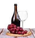 wine glass with red wine, bottle of wine and grapes isolated over white Royalty Free Stock Photo