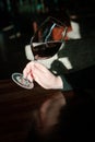 A wine glass of red wine in a women`s hand. Royalty Free Stock Photo