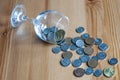 Wine glass on table coins money spent on alcohol closeup alcoholism