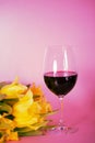 Wine glass with tulips, pink background, invitation card Royalty Free Stock Photo