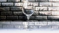 Empty glass of wine on a brick wall background,close-up Royalty Free Stock Photo