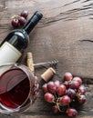 Wine glass, wine bottle and grapes on wooden background. Wine ta Royalty Free Stock Photo