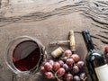 Wine glass, wine bottle and grapes on wooden background. Wine ta Royalty Free Stock Photo