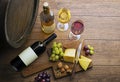 Wine bootle and glass with food on wooden table Royalty Free Stock Photo