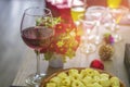 Wine glasses and cocktails and spirits and apples, and goldfish jar, Put on a wooden table at a Christmas party