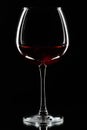 Wine glasses of different shapes and a bottle on a black background. A contour photo