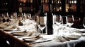 Wine and Glasses - Elegant Business Dinner, surrounded by wine glasses and place settings.