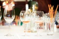 Two glasses of rose wine, empty glass and glass with water in a restaurant Royalty Free Stock Photo
