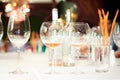 Two glasses of rose wine, empty glass and glass with water in a restaurant