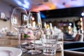 Wine glasses in the foreground. Wedding Banquet or gala dinner. The chairs and table for guests, served with cutlery and Royalty Free Stock Photo