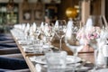 Wine glasses in the foreground. Wedding Banquet or gala dinner. The chairs and table for guests, served with cutlery and Royalty Free Stock Photo