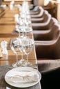 Wine glasses in the foreground. Wedding Banquet or gala dinner. The chairs and table for guests, served with cutlery and Royalty Free Stock Photo